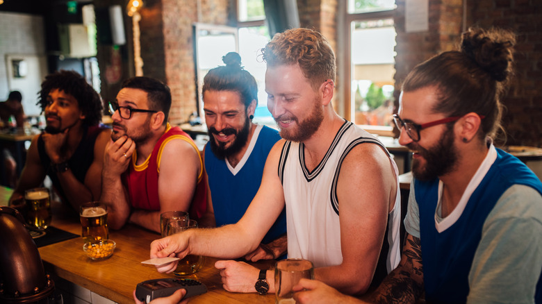 Group of guys smiling at a bar