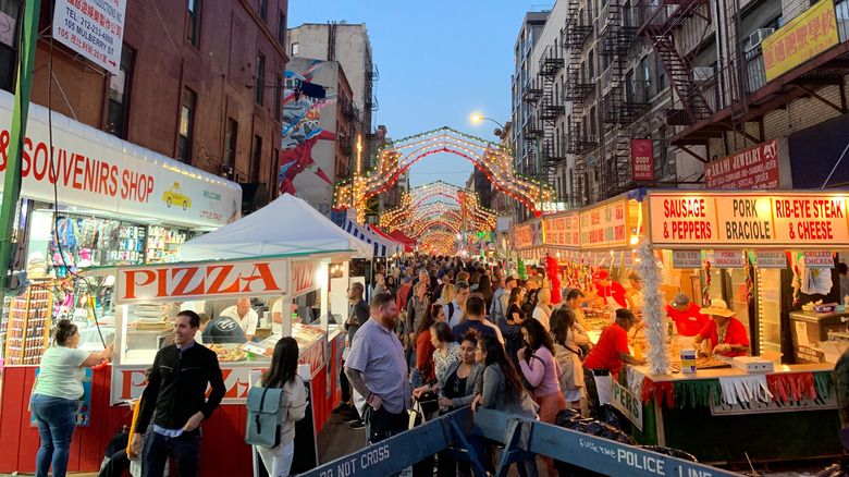 People on a New York City crowded with food stalls and vendors at the Feast of San Gennaro in Little Italy