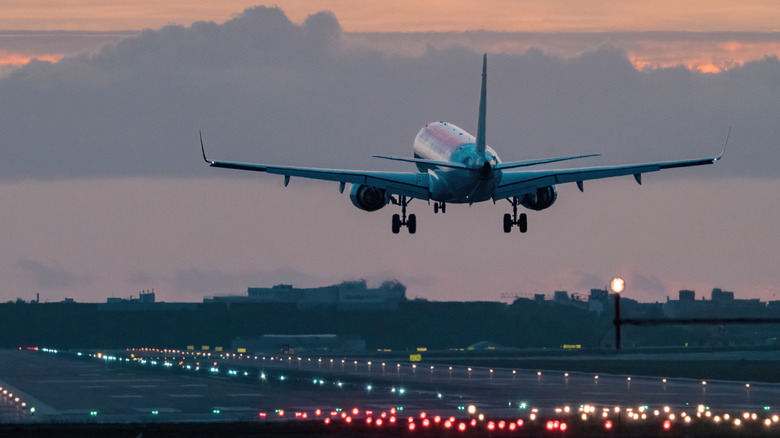 An airplane moving to land at an airport during the morning