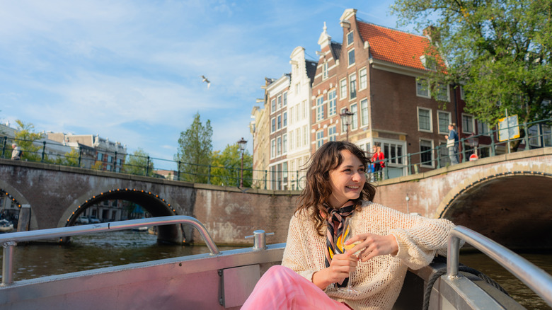 Smiling young woman on a boat in Amsterdam