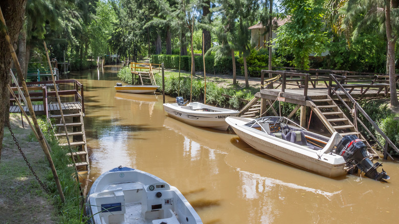 Boats anchored to canal bridges in the delta canals of Tigre Argentina