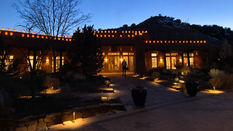 Ojo Caliente Mineral Springs building at dusk with warm lighting.