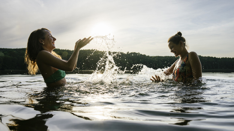 Splashing in a lake at sunset.