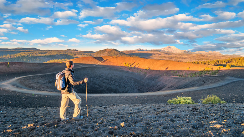 A man hiking on the Cinder Cone Rim in Lassen Volcanic National Park.