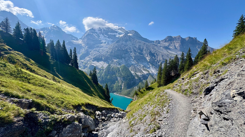 A blue lagoon surrounded by the glacial peaks of Jungfrau-Aletsch in Switzerland