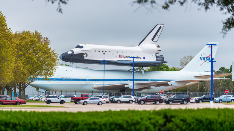 A space shuttle replica mounted on the historic and original NASA 905 shuttle carrier aircraft are seen on display at Space Center Houston's Independence Plaza