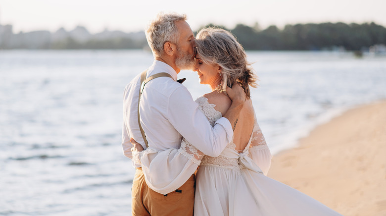 Older couple at a beach wedding