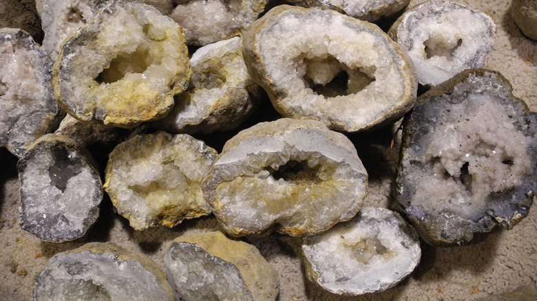 Closeup of a several cut up rocks with crystalline cross-sections, bunched together