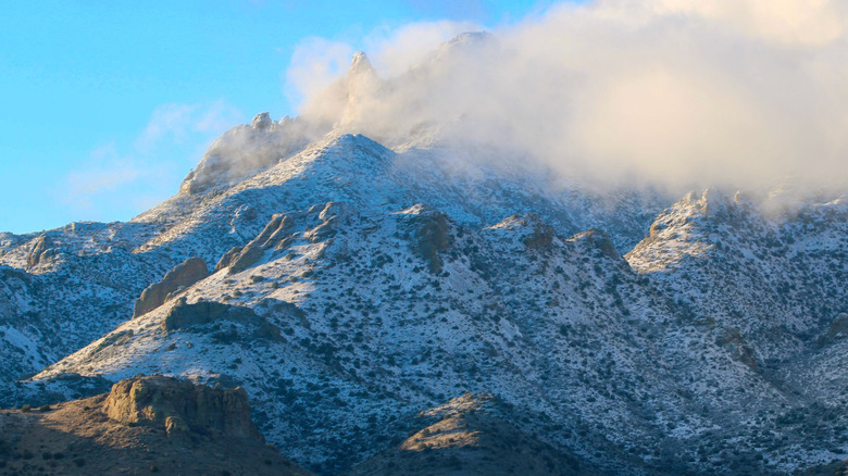 Snow covered mountains from up close with a cloud cover on top