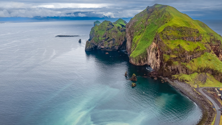 Aerial view of greenery-covered Westman Islands by the water in Iceland