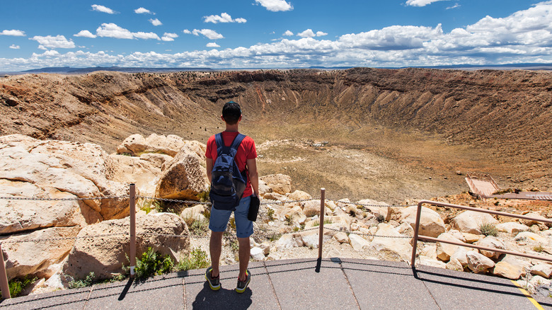 Man standing on platform around Meteor Crater