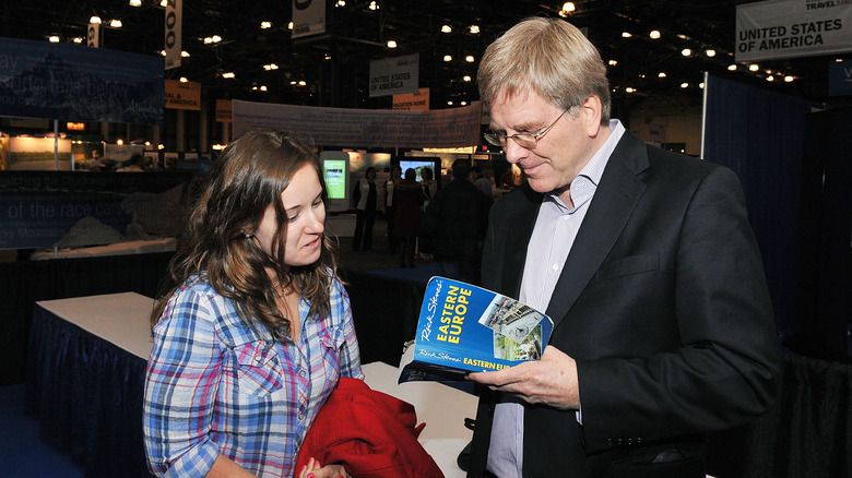 Rick Steves signing guidebook