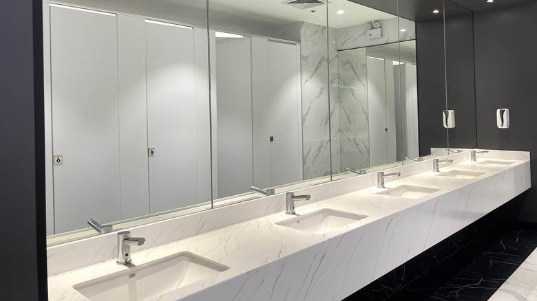Sinks and mirrors in a clean restroom.