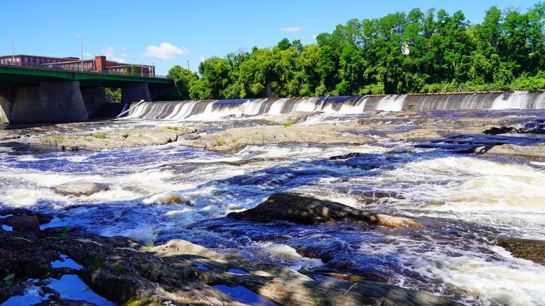 Turbulent river with dam and waterfall