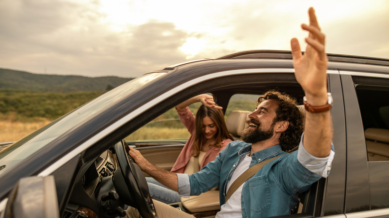 Couple singing in the car during a road trip