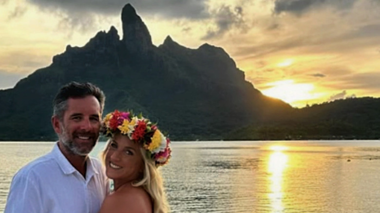 A couple enjoting a scenic sunset over the water on Bora Bora