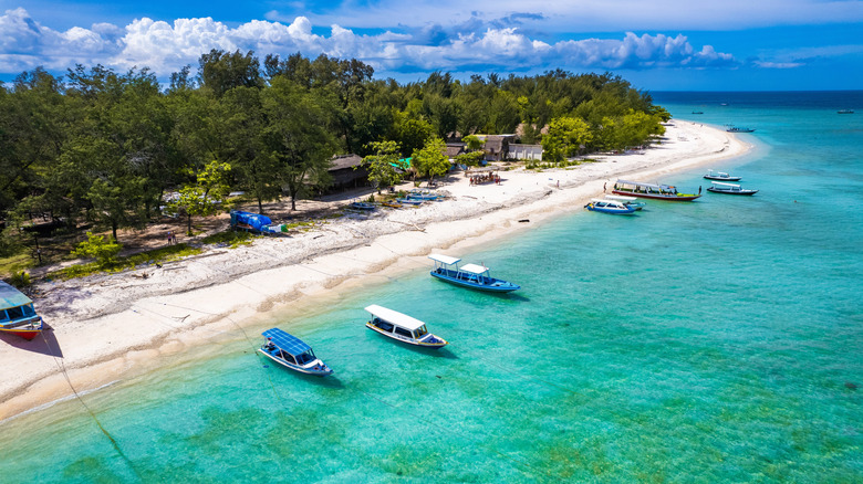 An aerial view of the shoreline at Gili Meno, with white beaches and boats on the water