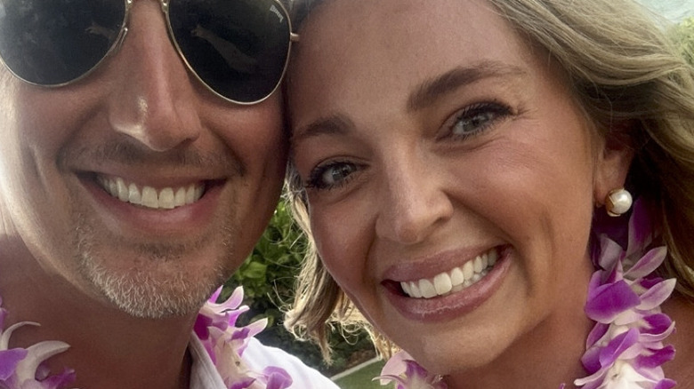 A couple on honeymoon in Maui, wearing leis.
