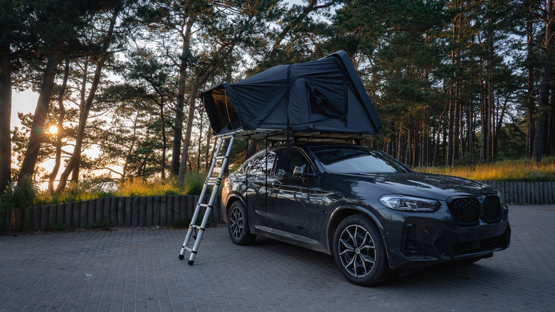 Rooftop tent on top of a black sedan