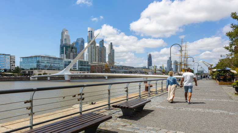 Couple walking along river in Buenos Aires, Argentina