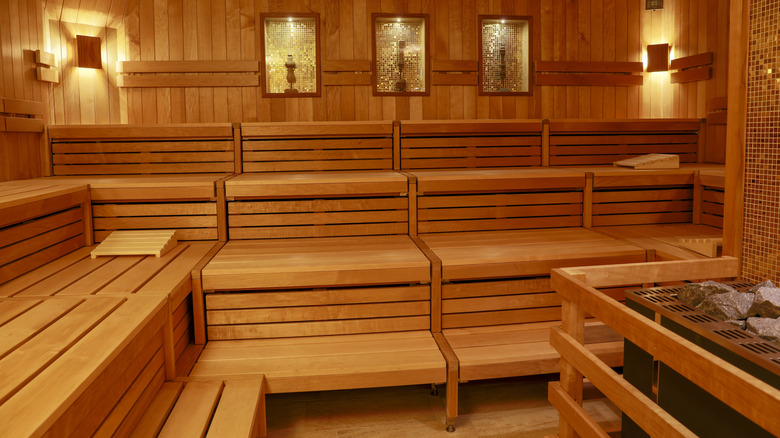 Inside an empty sauna room with wooden seating