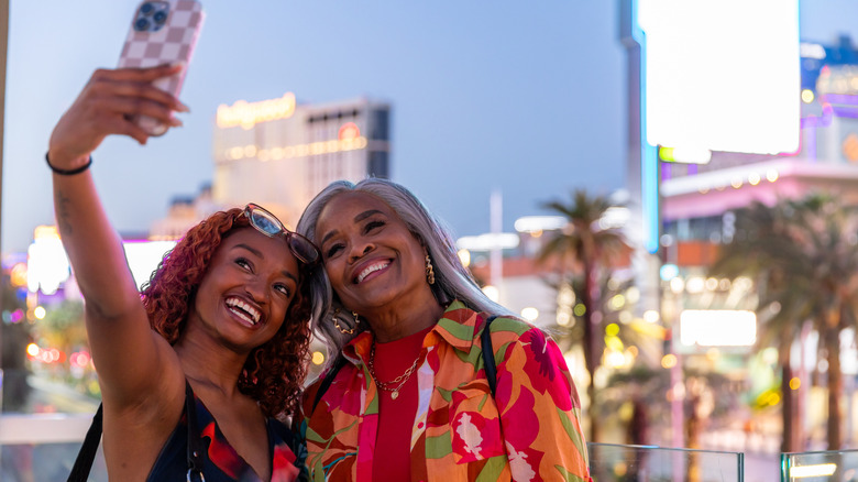a mother and daughter take a selfie in front of Las Vegas Strip