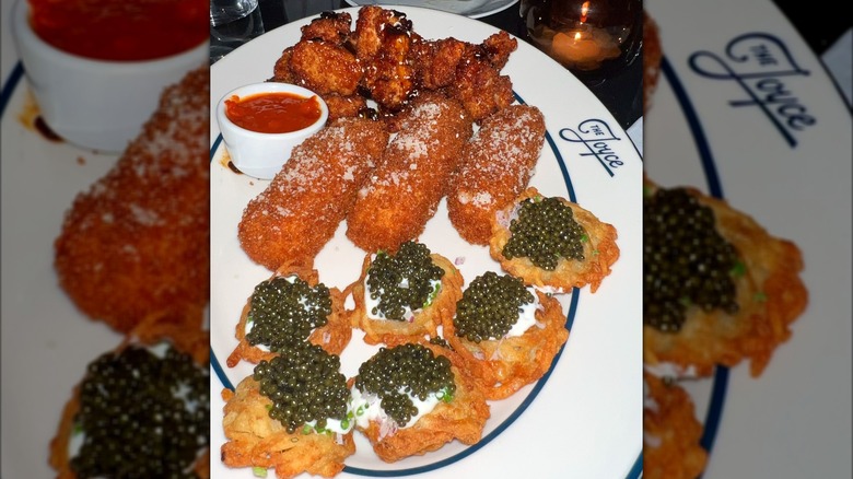 Caviar-topped latkes, chicken wings, and other starters at The Joyce
