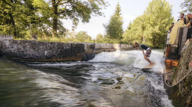 Person riding a wave on the Almkanal in Salzburg