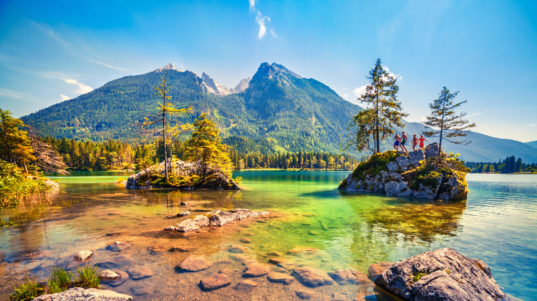 People on a rock in the middle of lake Hintersee
