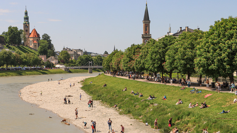 People swimming along a beach river