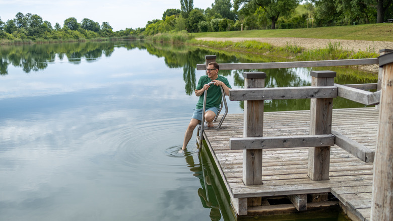 Man dipping his leg into a pool