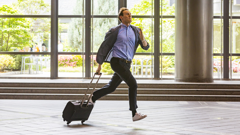 man running through airport