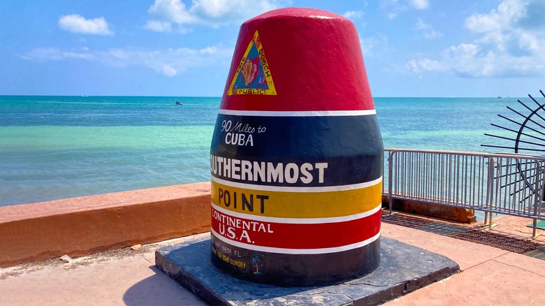 The colorful Southernmost Point Buoy in front of the ocean in Key West