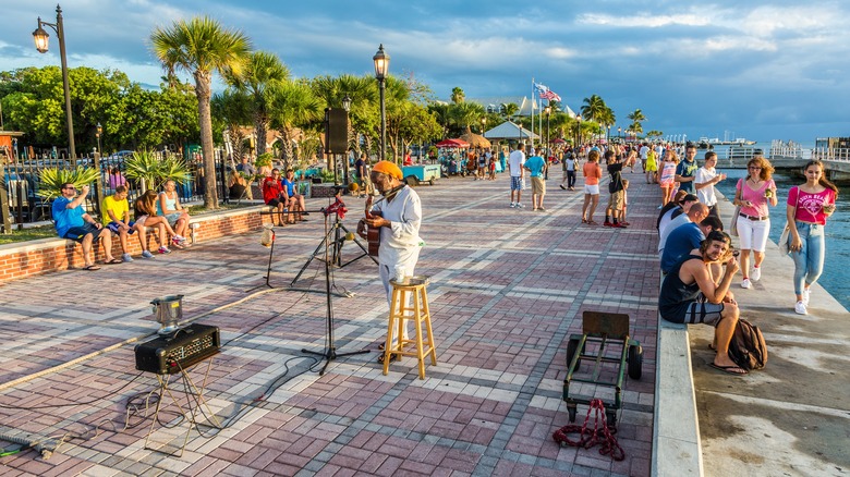 Musician in Mallory Square and people watching sunset