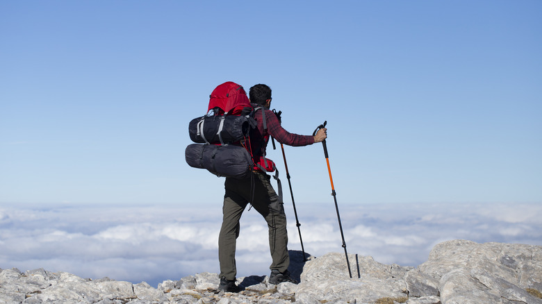 Backpacking hiker on top of mountain