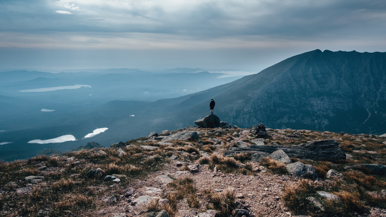 Hiker standing atop mountain in Baxter State Park