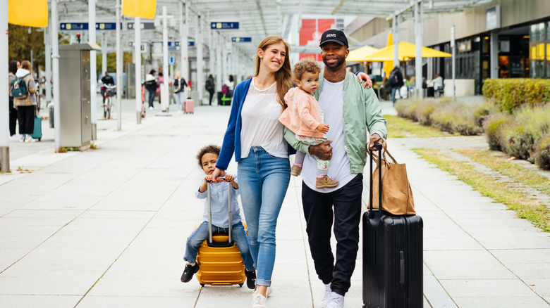 Happy family at the airport for a vacation