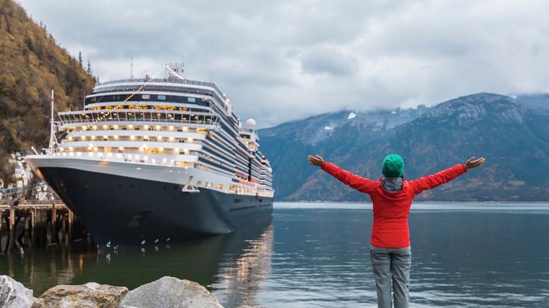 Person welcomes cruise ship to Alaska