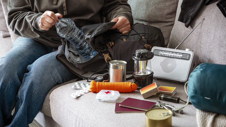 A traveler unpacks their disaster supplies