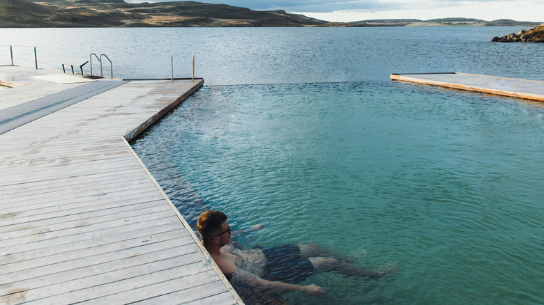 A man partaking in a solo soak at Vök Baths