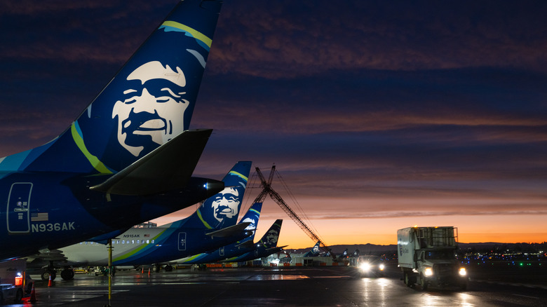 Alaska Airlines planes on the tarmac at sunset