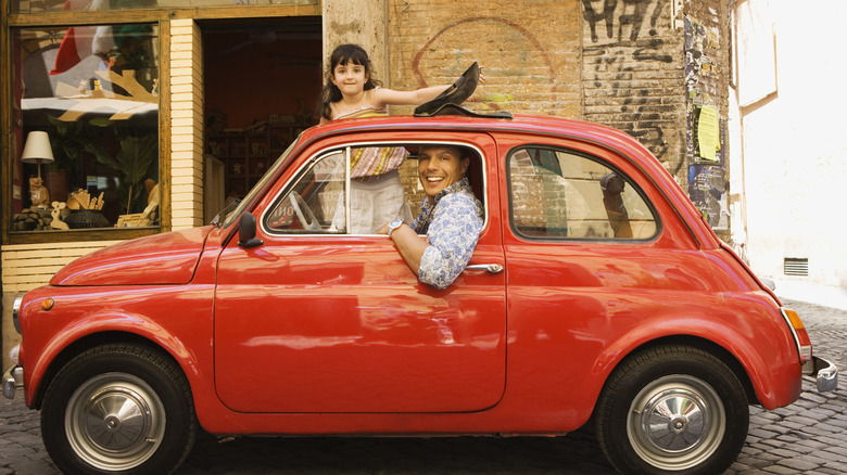 Dad and daughter in European car