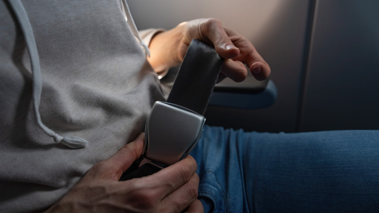 Person touching seat belt