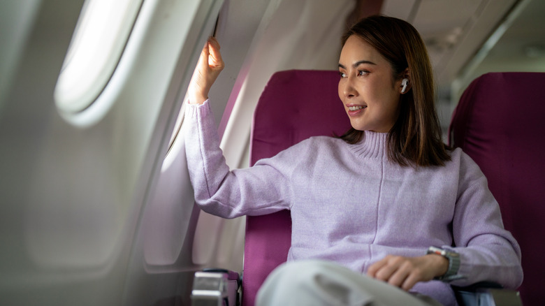 A woman sitting in an airline seat