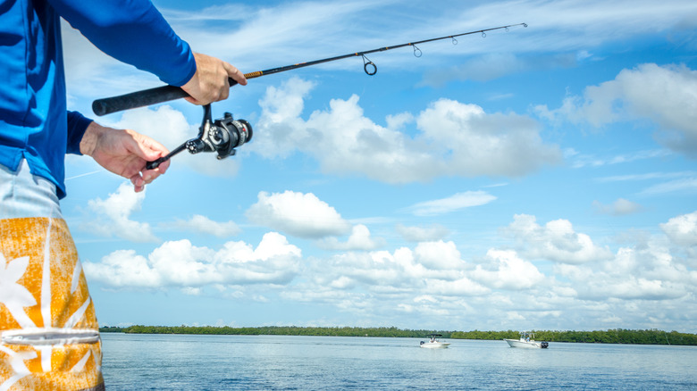 Man casting a fishing line into Florida waters
