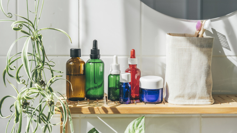 A row of toiletries on a bathroom shelf