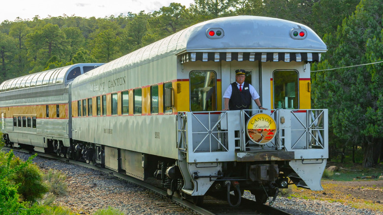 A conductor on the back of a train car
