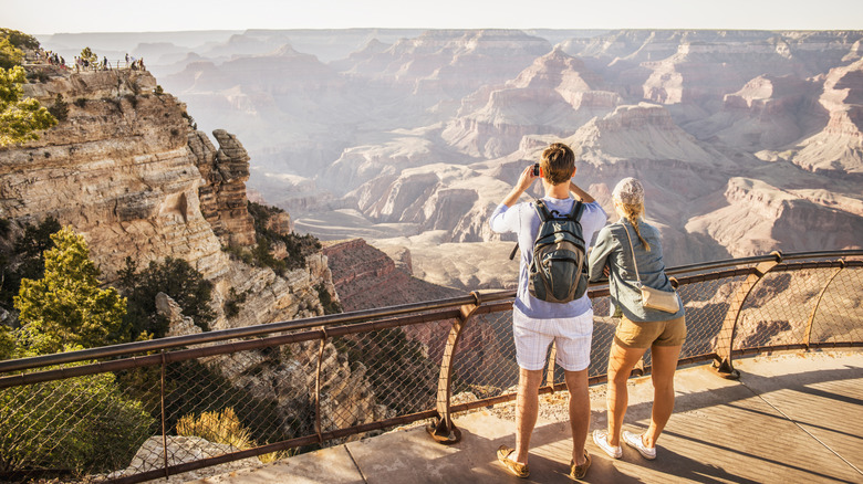 A couple looking out over the Grand Canyon