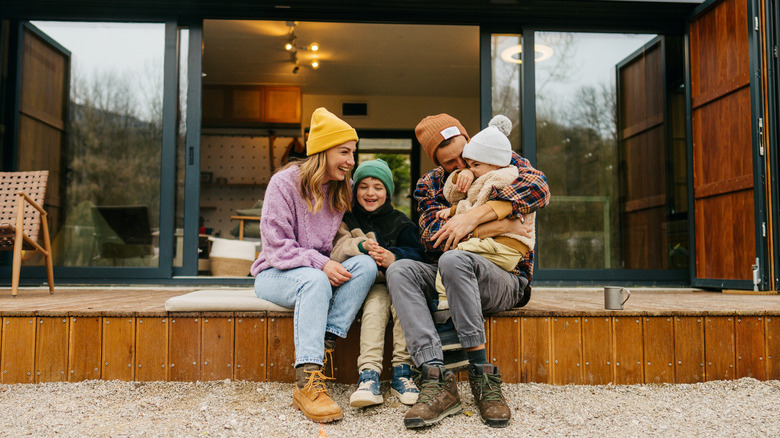 Happy family outside house