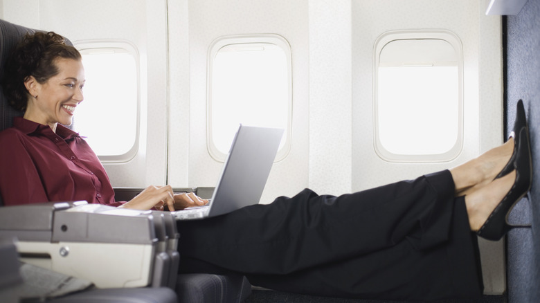 A woman sitting in a first class seat